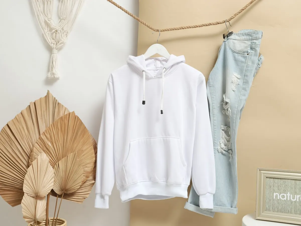 Hoodies & Sweatshirts: plain white hoodie hanging beside jeans — reference photo from our export range